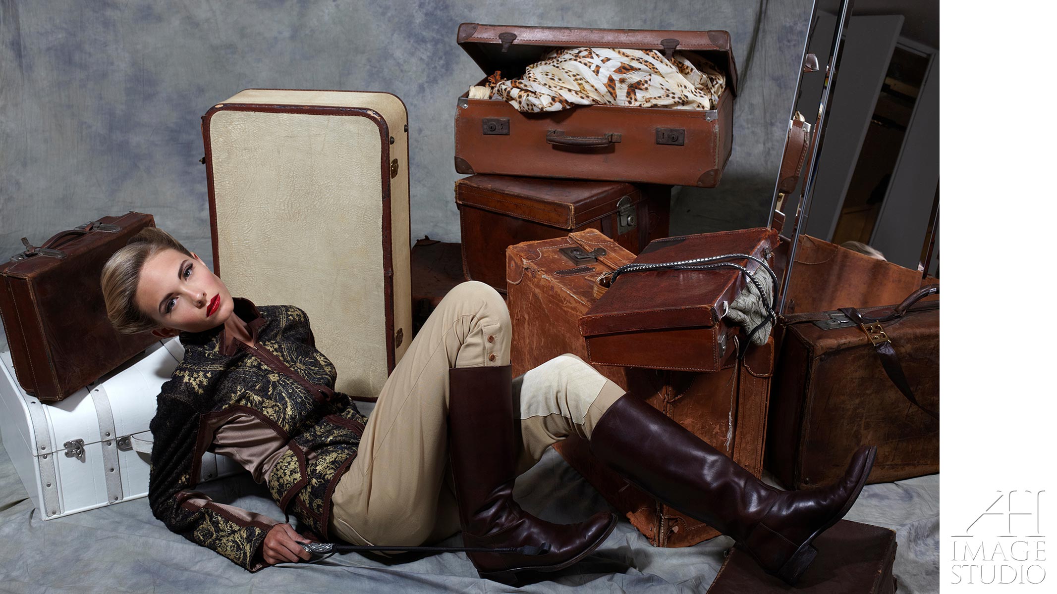 fashion photo shot with suitcases horse riding boots
